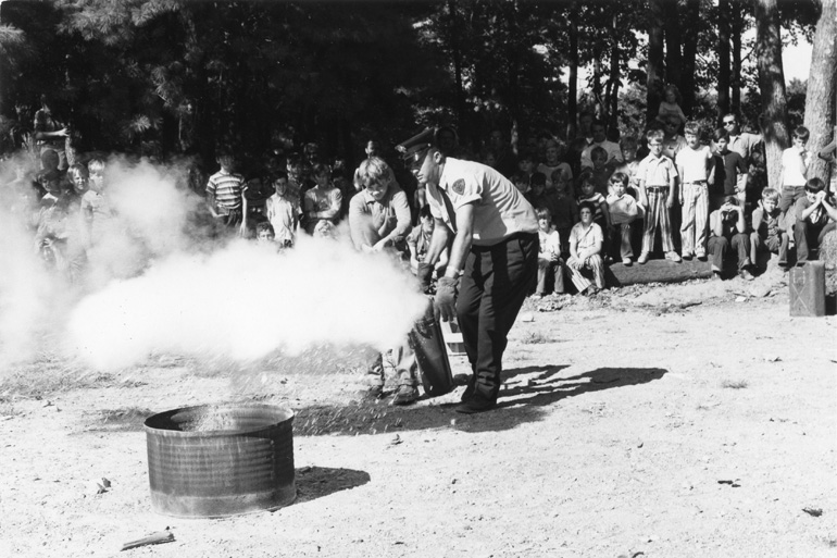 Robert Bennett supervises hands-on practice with a fire extinguisher
during an all-day fire safety program